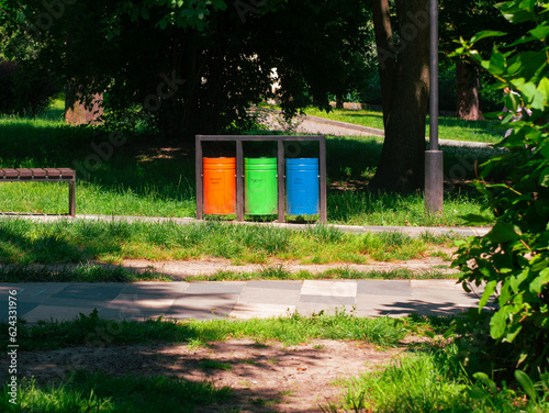 Colorful metal recycle trash bins for paper, glass, plastic, general waste in public park urban area. Keep clean environment ecology. Garbage sorting containers Stop plastic pollution Waste management