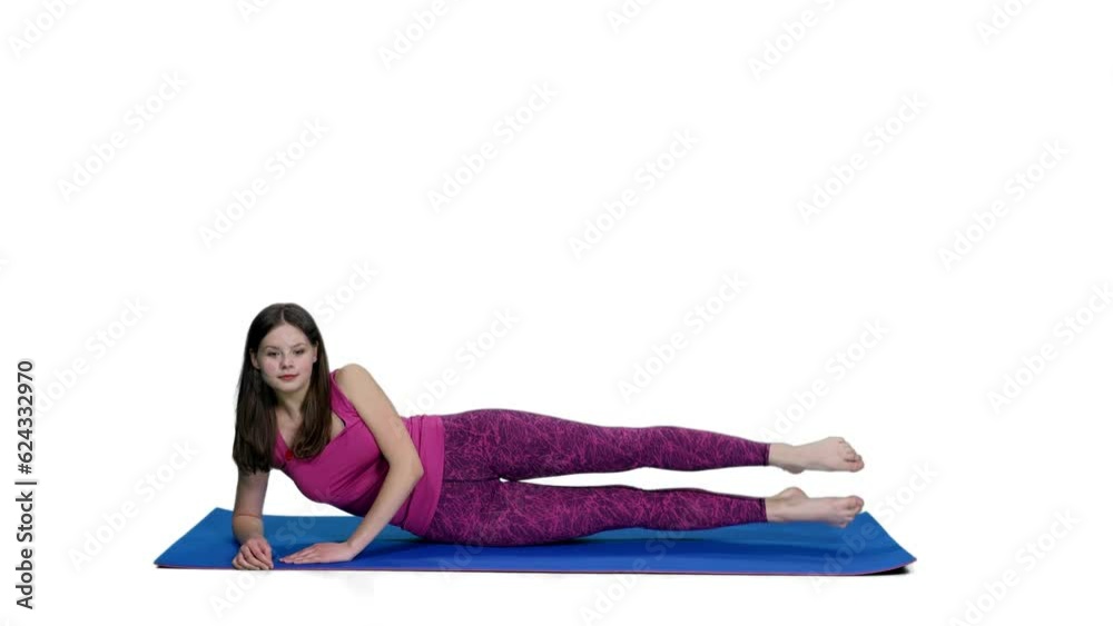 Smiling young female in pink top practicing fitness on yoga mat, Full HD footage with alpha transparency channel isolated on white background Smiling young female in pink top practicing fitness on yoga mat, Full HD footage with alpha transparency channel isolated on white background