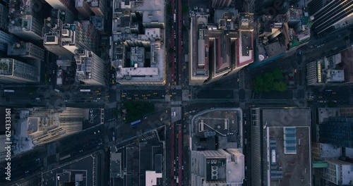 Top Down Aerial View of New York City Streets with Visible Grid System, Business and Residential Building Roofs. Busy Metropolis Traffic with Cars, Yellow Taxis, Commercial Vehicles and People Walking