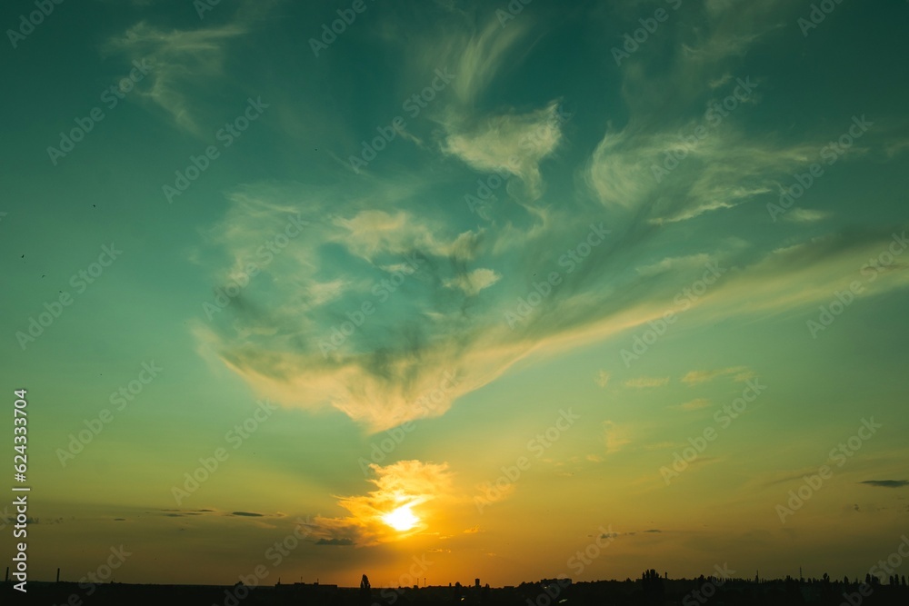 Colorful sky at sunset with powerful cumulus clouds, Ukrainian landscape
