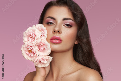 Portrait beautiful young woman with clean fresh skin. Model with healthy skin  close up portrait. Cosmetology  beauty and spa. Girl with a rose flower