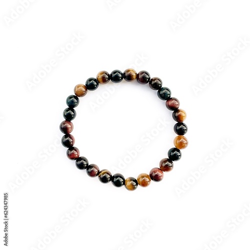 Obraz na plátne Tiger’s eye stone bracelet on white background