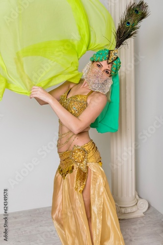Beautiful woman dancing oriental belly dance in costume