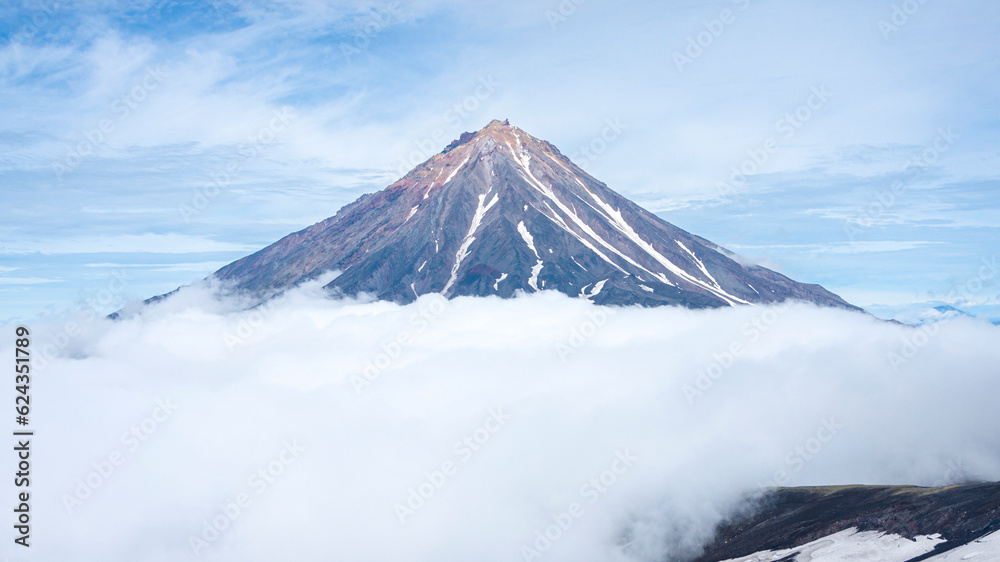 A beautiful view of Koryaksky Volcano in clouds. Kamchatka A beautiful view of Koryaksky Volcano in clouds. Kamchatka