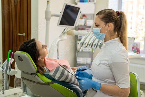 Female patient receives a professional consultation at a dentist clinic