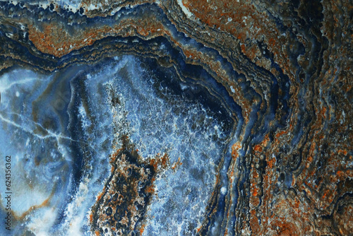Blue marble. Natural pattern of blue marble. Abstract and blue marble as the design background. A pattern of brown inclusions.Background for designers. Marble tiles for the floor or walls.