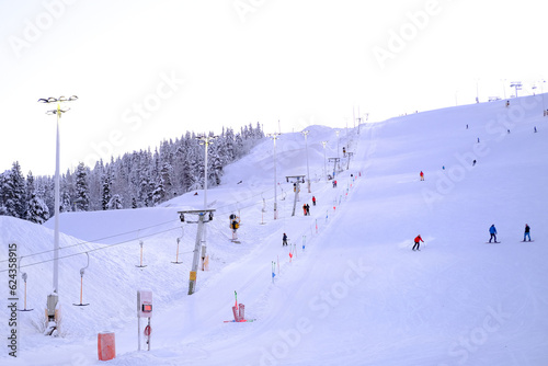Levi ski resort, toboggan run, funicular cabins go uphill, , spruce in snow, beautiful winter landscape, concept holiday in lapland, winter sports, frosty air walks in forest, New Year's fairy tale