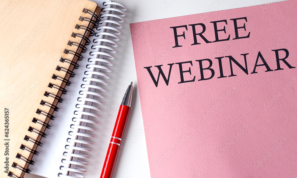 FREE WEBINAR word on the pink paper with office tools on white background FREE WEBINAR word on the pink paper with office tools on white background