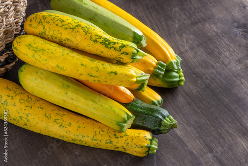 Yellow-green leopard-spotted zucchini. Vegetables on the table. Zucchini harvest.