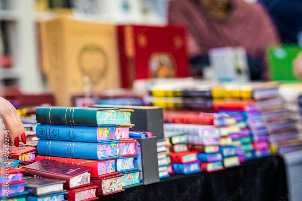 Obraz premium Abstract blurred background of pile books, textbooks, fiction in book store. Education, study, reading