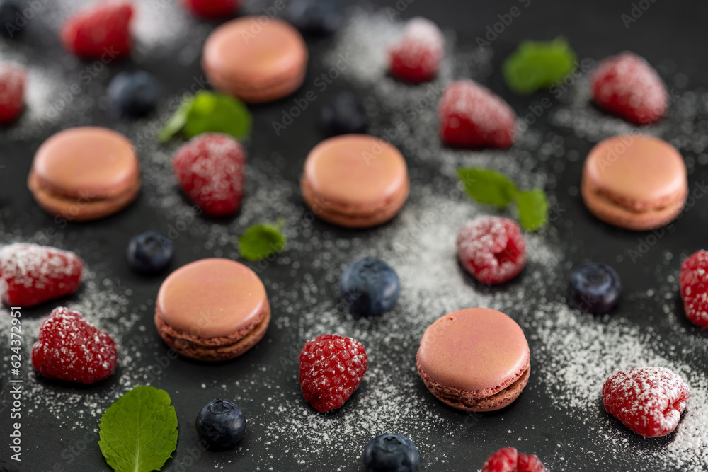 macaroons of different colors on a black background macaroons of different colors on a black background