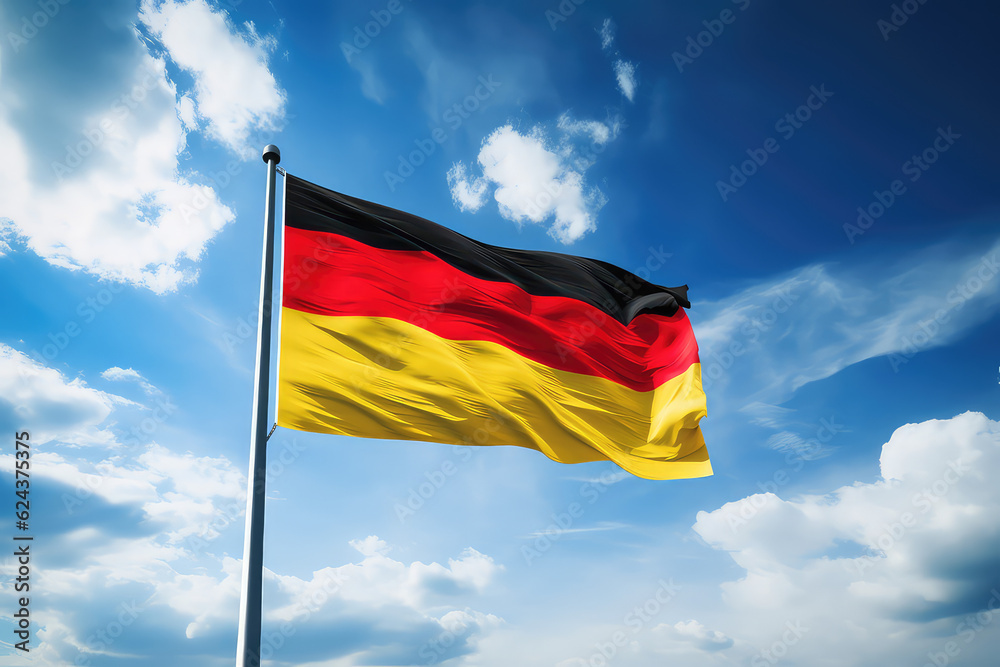 Germany flag flying in the wind on a flagpole against a blue sky with clouds. Black red yellow flag of the Germany wallpaper. Germany flag flying in the wind on a flagpole against a blue sky with clouds. Black red yellow flag of the Germany wallpaper.