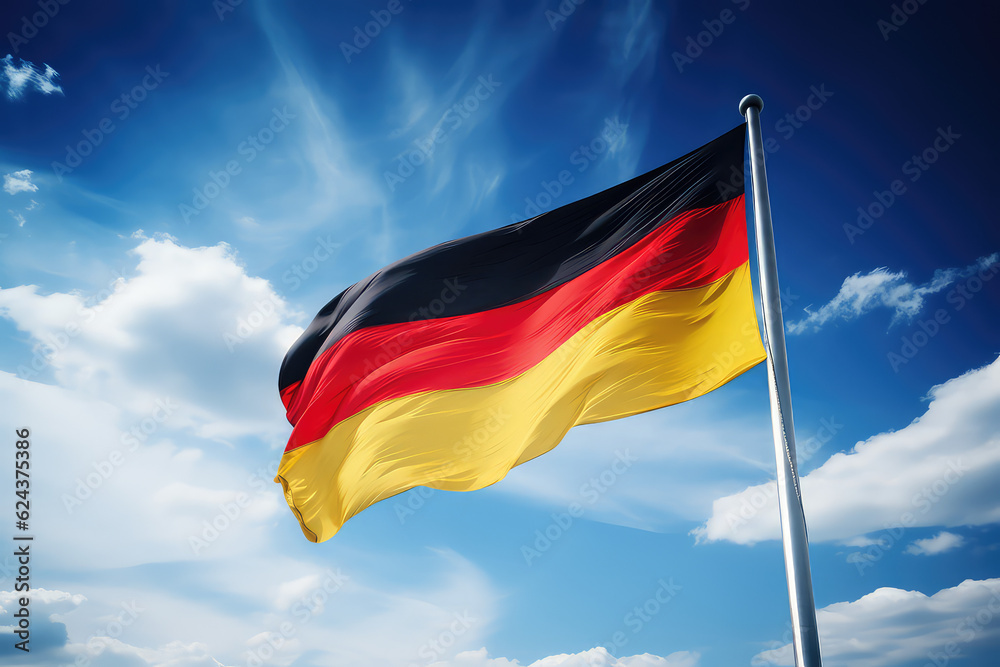 Germany flag flying in the wind on a flagpole against a blue sky with clouds. Black red yellow flag of the Germany wallpaper. Germany flag flying in the wind on a flagpole against a blue sky with clouds. Black red yellow flag of the Germany wallpaper.