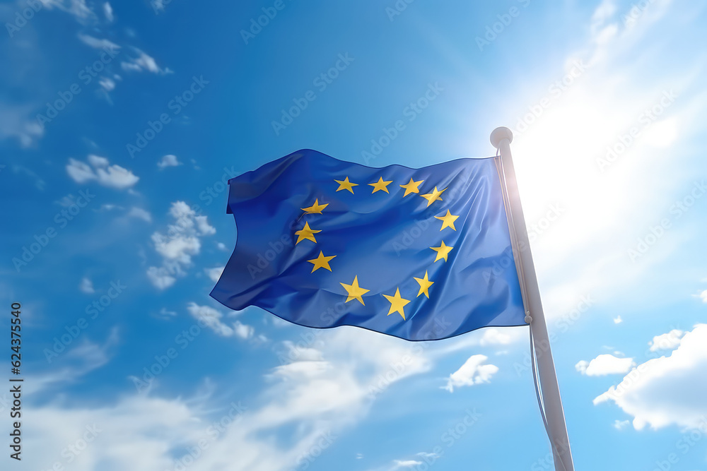 European flag flying in the wind on a flagpole against a blue sky with clouds. Blue flag of the European Union wallpaper.  