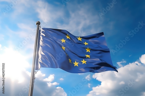 European flag flying in the wind on a flagpole against a blue sky with clouds. Blue flag of the European Union wallpaper. 