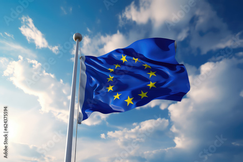 European flag flying in the wind on a flagpole against a blue sky with clouds. Blue flag of the European Union wallpaper. 