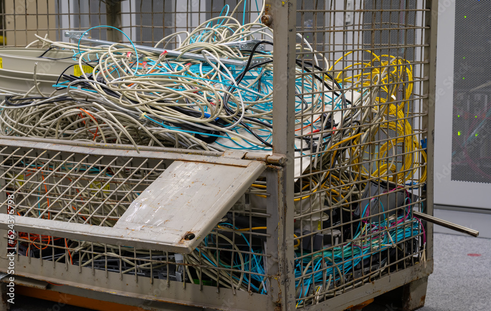 in the data center are old IT network cables and power cables stored in a lattice box for disposal
