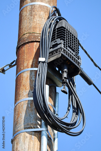 Internet router on a pole outdoor with cables photo