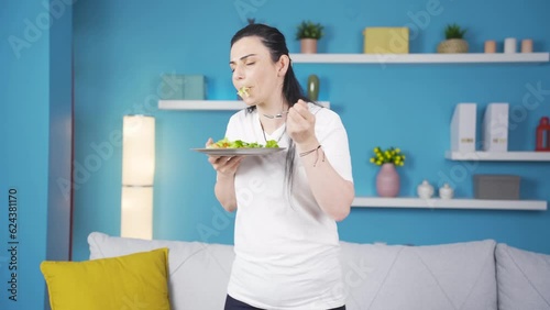 A person who diets and eats healthily. She eats salad and dances.