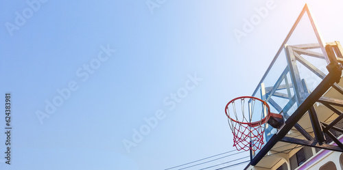 Basketball hoop and backboard with blue sky copy space