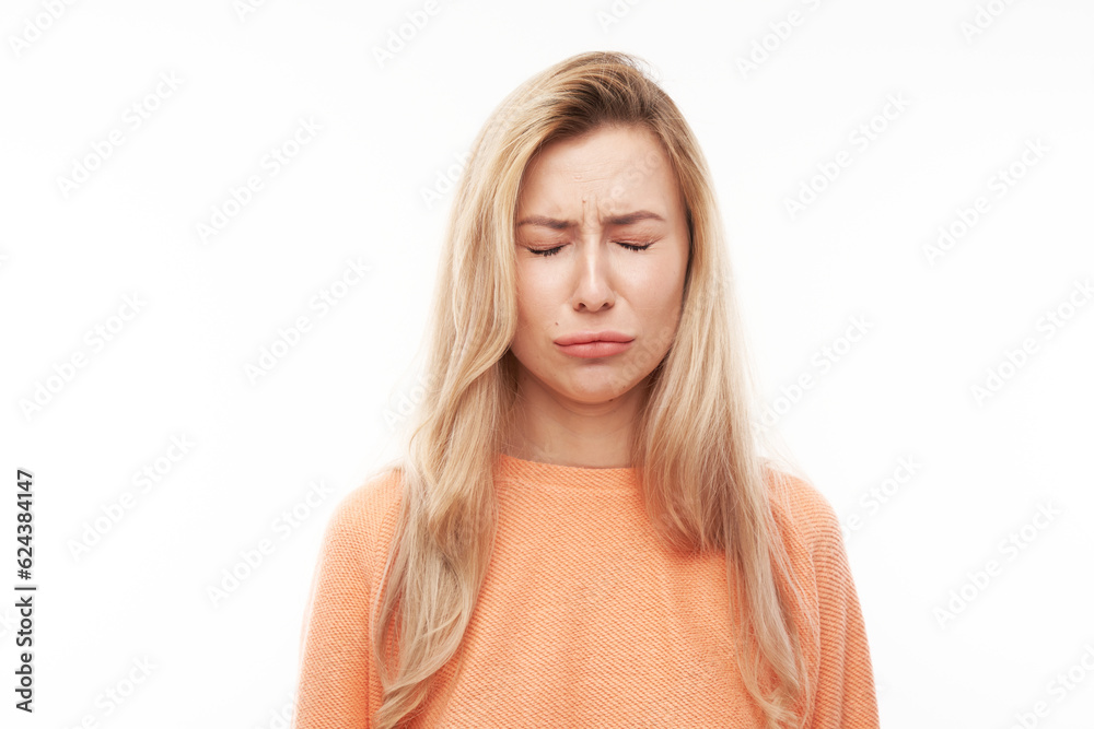 Portrait sad blonde young woman isolated on white studio background. Made mistake, upset and depressed face. Portrait sad blonde young woman isolated on white studio background. Made mistake, upset and depressed face.