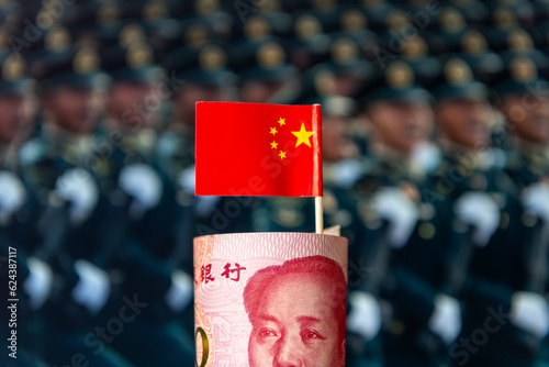 Photography A roll of Chinese bank notes and national flag with a military background