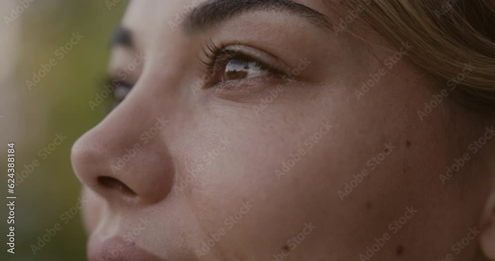 A closeup portrait of a young  woman looking away from the camera