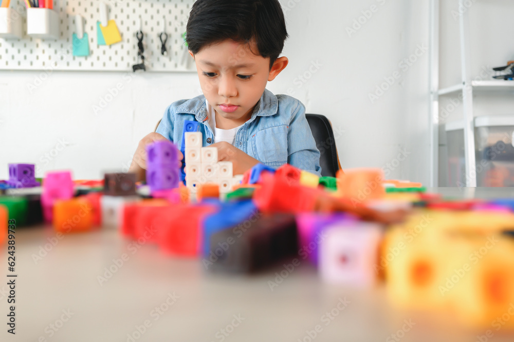 Asian Young Child Playing Colorful Plastic Cubes on Desk at Home ...