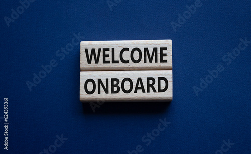 Welcome onboard symbol. Concept words Welcome onboard on wooden blocks. Beautiful deep blue background. Business and Welcome onboard concept. Copy space.