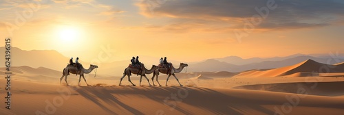 Caravan in the desert in the rays of the sun at sunset. Caravan in the desert in the rays of the sun at sunset. Delivery of goods and cargo to cities where there are no roads.