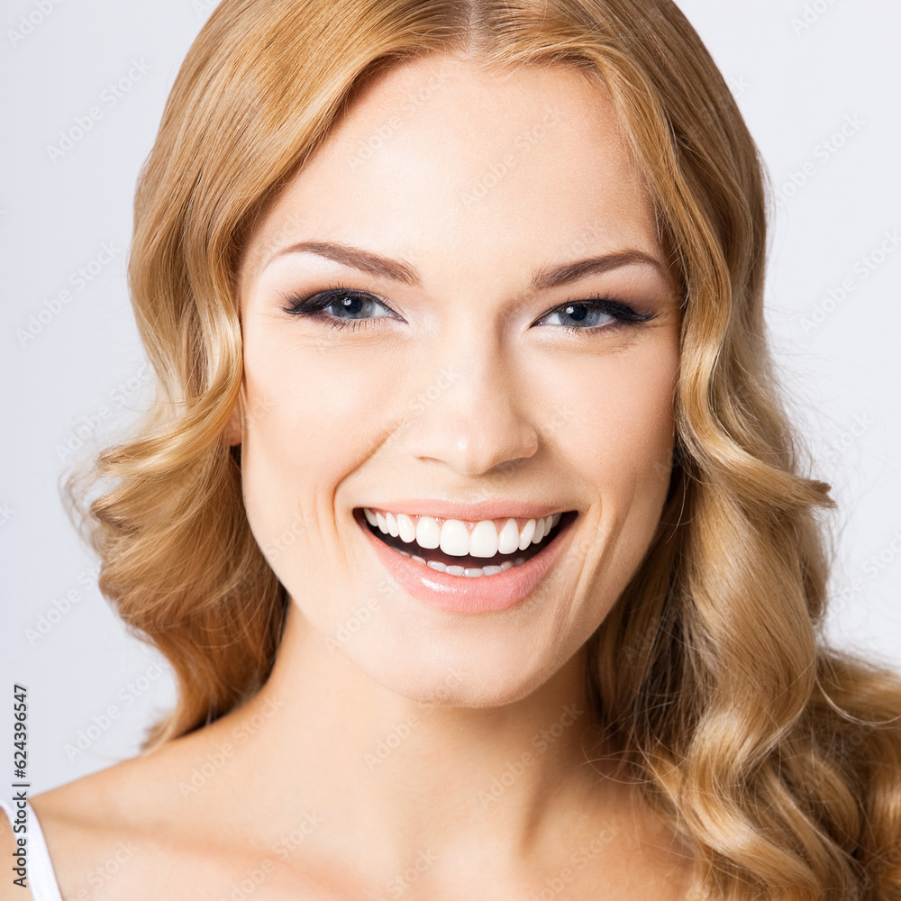 Face portrait photo of beautiful young cheerful smiling woman, over gray background. Happy amased attractive blond girl at studio. Dental health concept. Face portrait photo of beautiful young cheerful smiling woman, over gray background. Happy amased attractive blond girl at studio. Dental health concept.