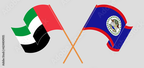 Crossed and waving flags of the United Arab Emirates and Belize