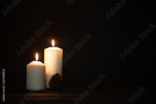 Burning candles and christmas decorations on a dark background