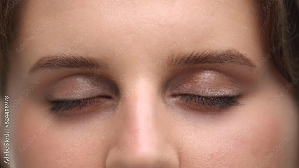 Close-up of closed female eyes of a beautiful woman.