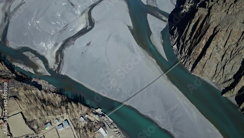 Hussaini Suspension bridge known as the most dangerous bridge in world is only one of many precarious rope bridges in Northern Pakistan and indus river flowing below at Hussaini Village Hunza Valley