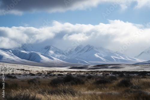 view of snow-covered mountain range, with clouds and sky in the background, created with generative ai