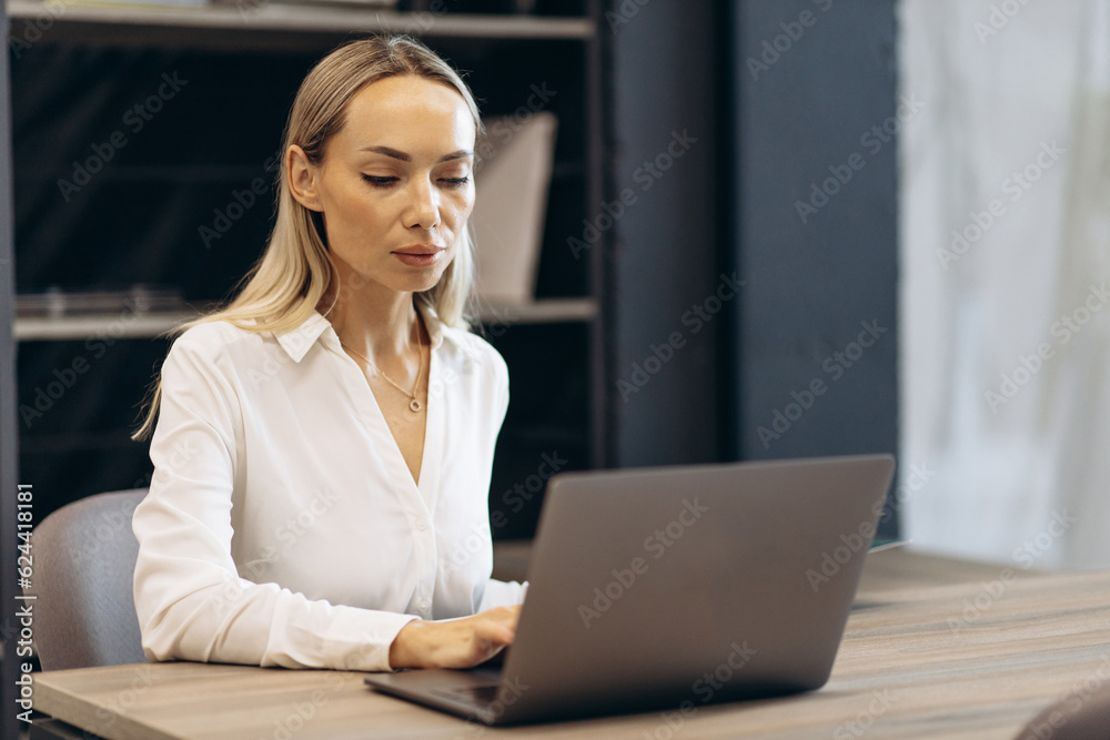 Woman working on laptop in building market with tiles Woman working on laptop in building market with tiles