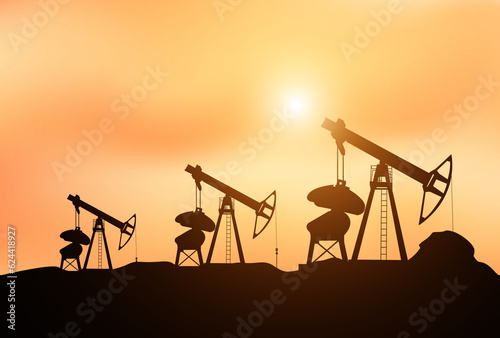 Oil pump oil rig energy industrial machine for petroleum in the sunset background for design 
