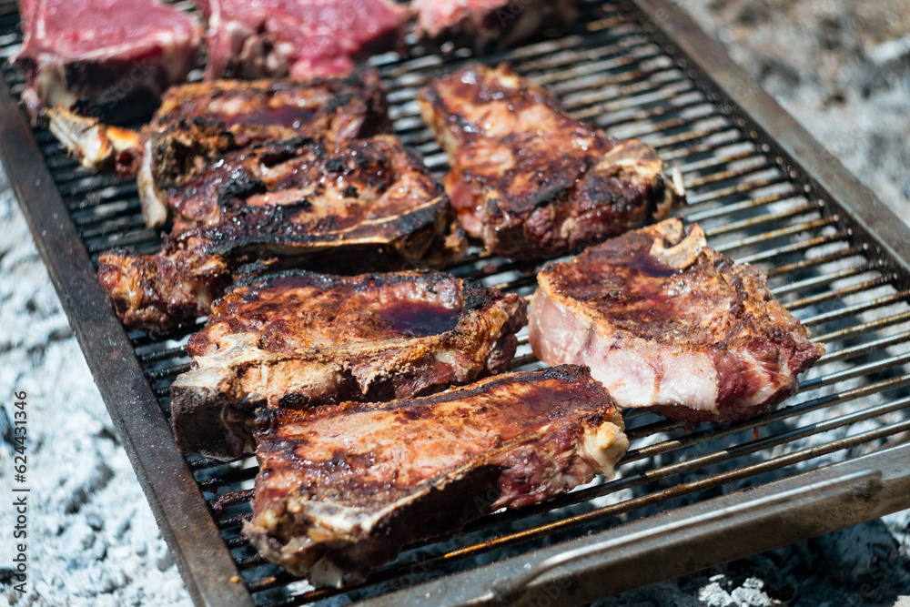 raw Agrentina beef steak bone cooking on bbq  grill