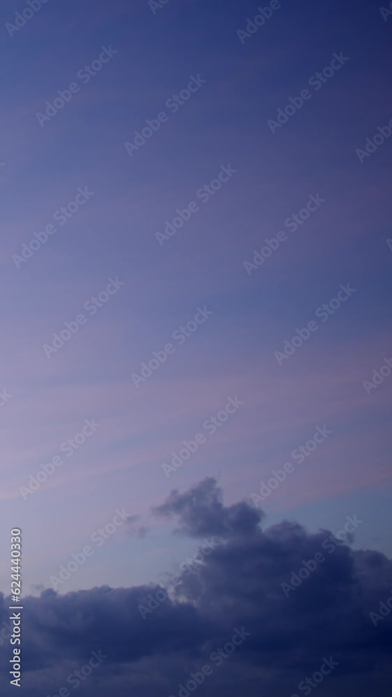 A vertical time-lapse video showcases the twilight sky, including a purple color palette and quickly moving clouds. A vertical time-lapse video showcases the twilight sky, including a purple color palette and quickly moving clouds.