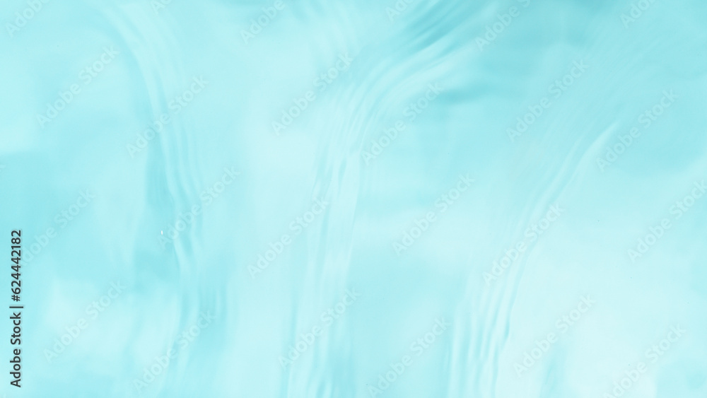 Freeze motion of splashing water surface on light blue background Freeze motion of splashing water surface on light blue background