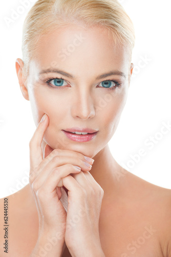 Portrait of a young woman with blonde hair and blue eyes looking at the camera with a white background