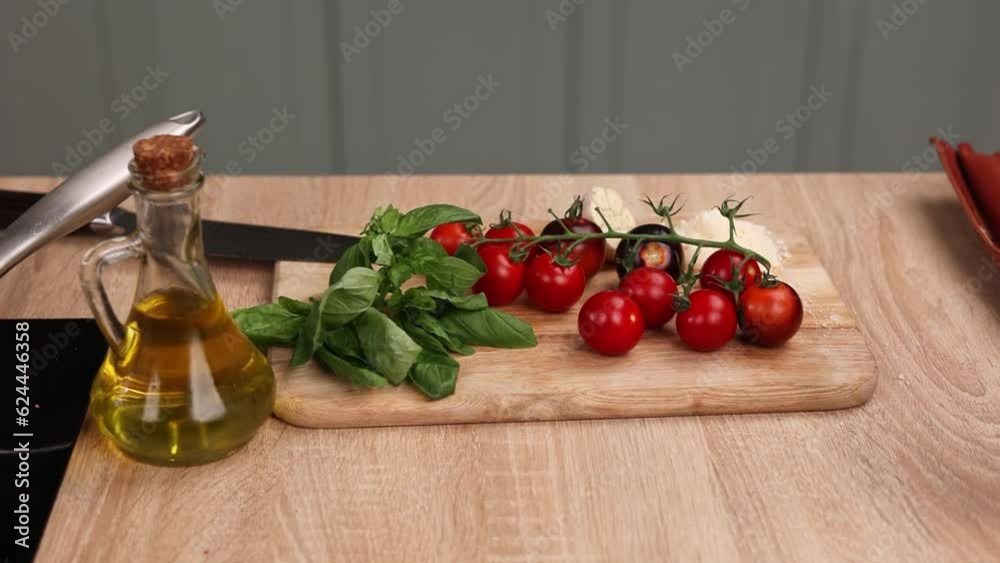 Chef prepares a delicious dish with tomatoes in the kitchen. Close-up Chef prepares a delicious dish with tomatoes in the kitchen. Close-up