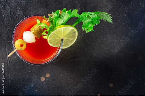 Bloody Mary cocktail with garnish on a black background, overhead flat lay shot with copy space. Spicy tomato juice with alcohol
