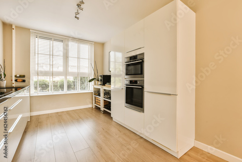 a kitchen with white cabinets and black appliances on the counter top in front of the oven, sink and dishwasher