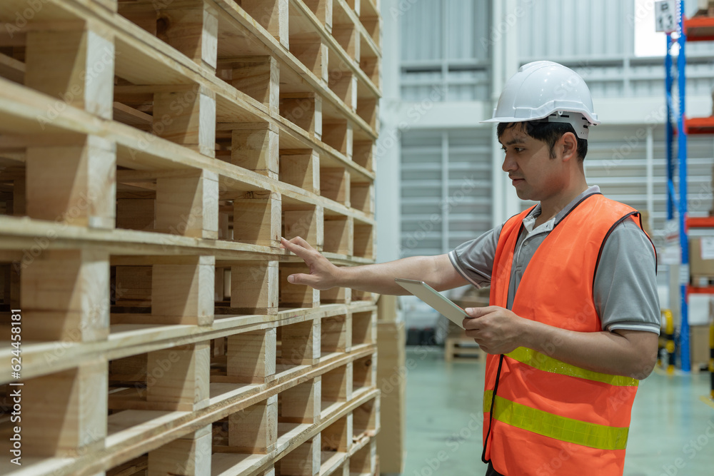 Asian male factory inspect pallet in warehouse or inventory and check stock product. Transport logistic business shipping, delivery to customers. inspection, storehouse, storage, factory