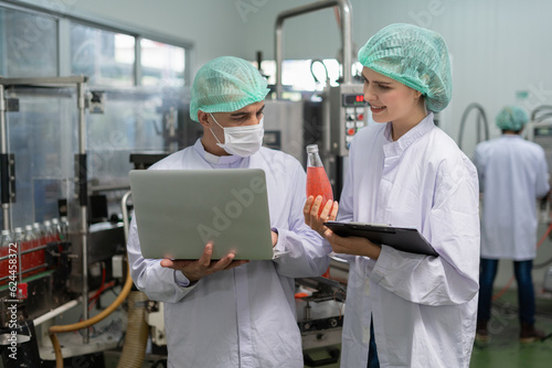 quality supervisor or food or beverages technician discuss about process control of food and drugs before send product to the customer. Production leader recheck ingredient and productivity.