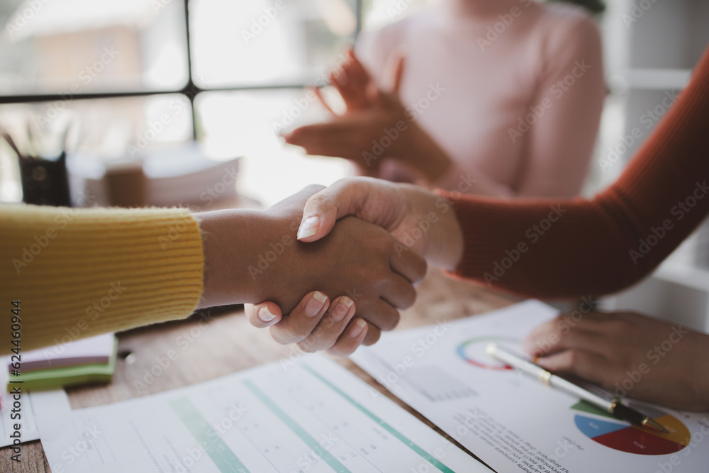 Fototapeta premium Business investor group shakes hands, Two businessmen are agreeing on business together and shaking hands after a successful negotiation. Handshaking is a Western greeting or congratulation.