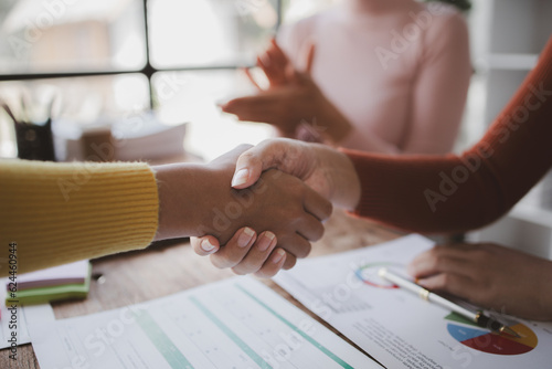 Business investor group shakes hands, Two businessmen are agreeing on business together and shaking hands after a successful negotiation. Handshaking is a Western greeting or congratulation.