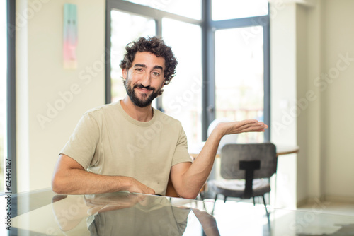 young bearded man with a copy space on a table